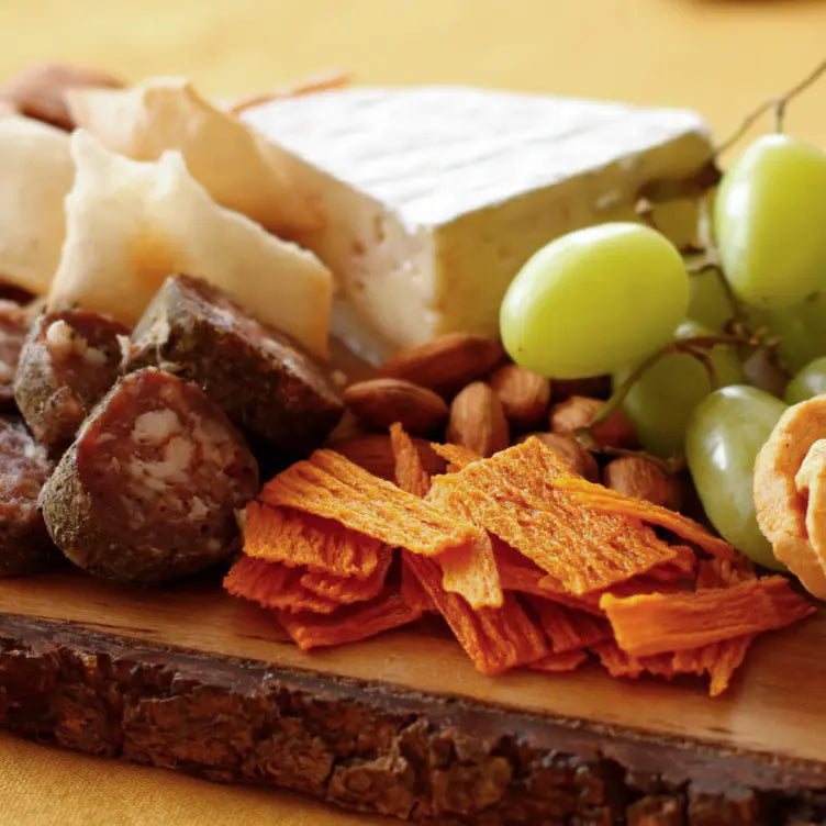 Charcuterie board with grapes, cheese and TASU chips