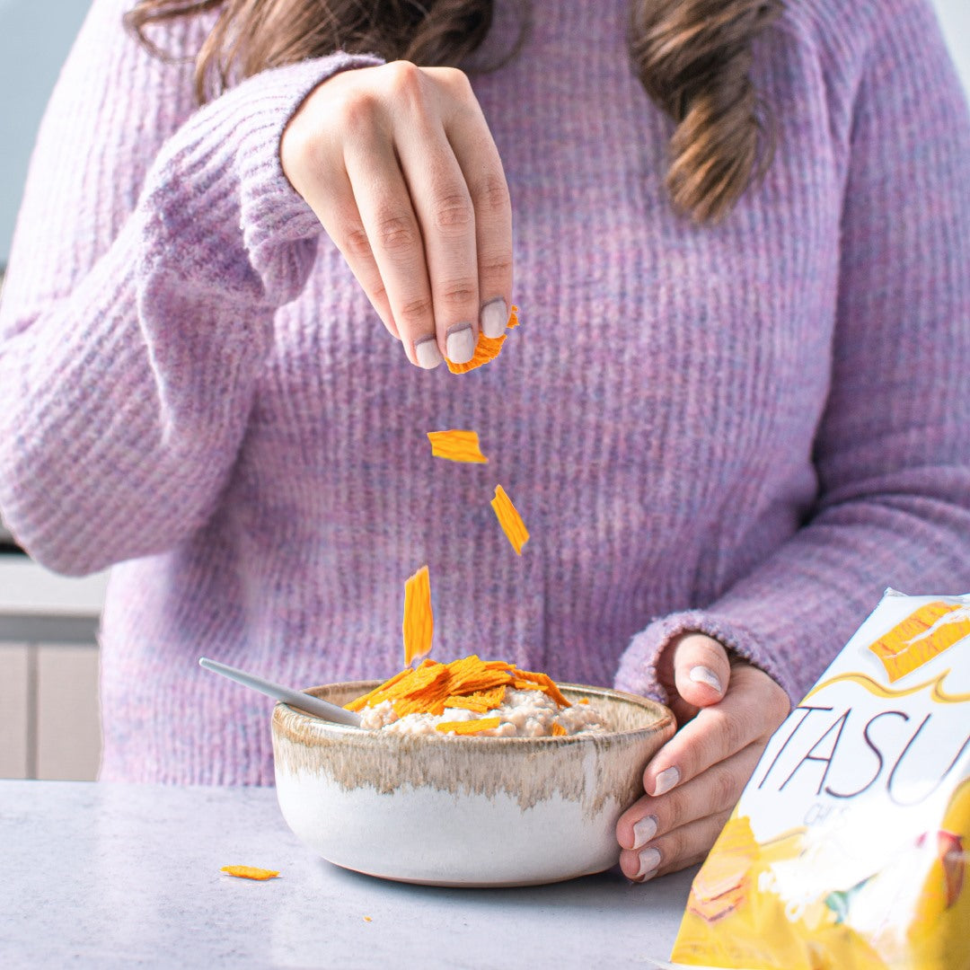 Woman topping her yogurt with TASU Fruit Chips
